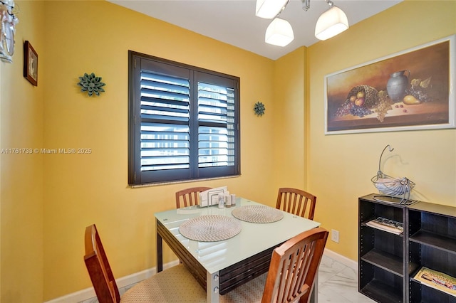 dining room featuring baseboards and marble finish floor