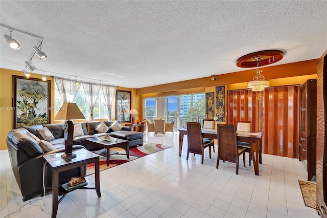 living area featuring light tile patterned floors and a textured ceiling