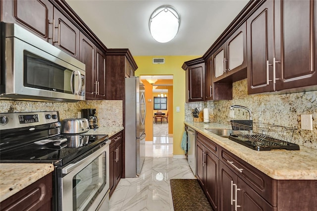 3800 Hillcrest Dr Unit 412, Hollywood, FL 33021 - kitchen with stainless steel appliances, a sink, light marble finish flooring, tasteful backsplash, and dark brown cabinetry