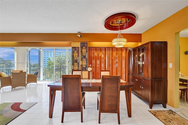 dining room with light tile patterned floors and a textured ceiling