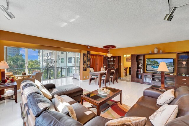 3800 Hillcrest Dr Unit 412, Hollywood, FL 33021 - living area featuring track lighting, a textured ceiling, and light tile patterned floors