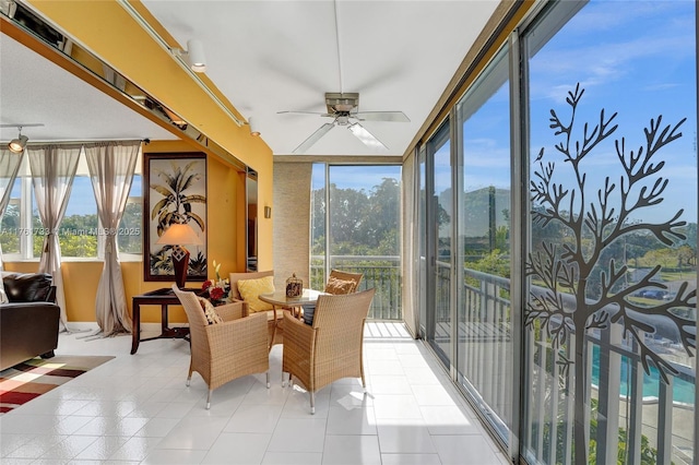 sunroom / solarium featuring ceiling fan