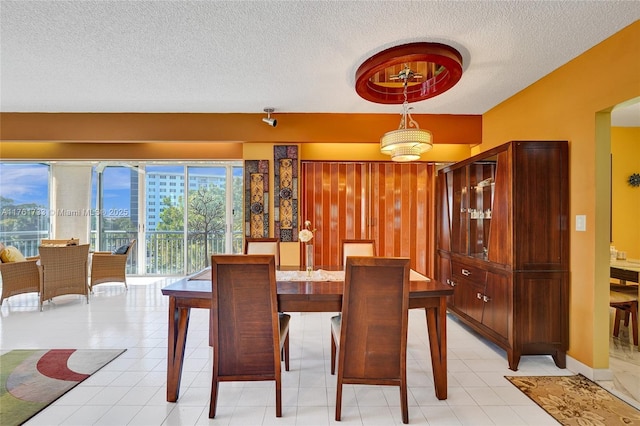 3800 Hillcrest Dr Unit 412, Hollywood, FL 33021 - dining room featuring a textured ceiling and light tile patterned floors