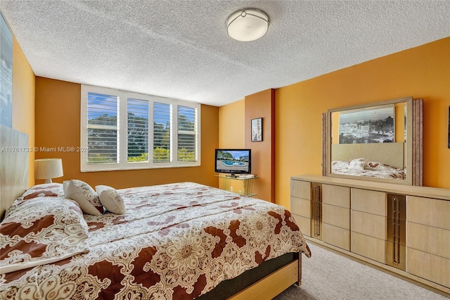 bedroom featuring a textured ceiling and carpet flooring