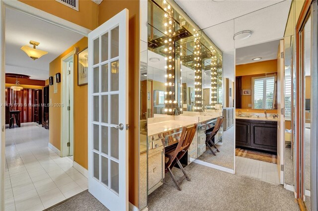 3800 Hillcrest Dr Unit 412, Hollywood, FL 33021 - home office with a sink, light tile patterned flooring, and light colored carpet