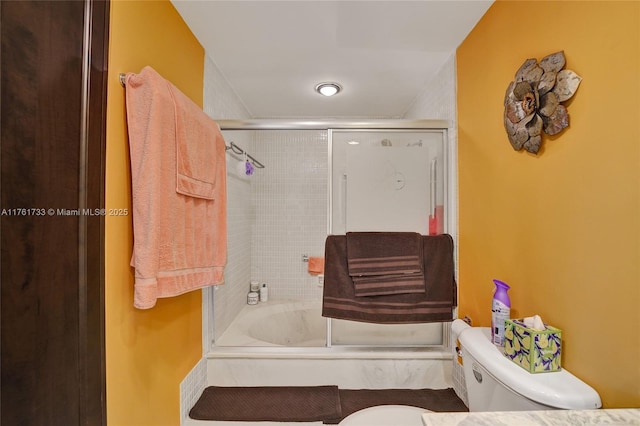 full bathroom featuring enclosed tub / shower combo and toilet