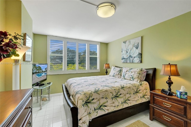 bedroom featuring light tile patterned floors and baseboards