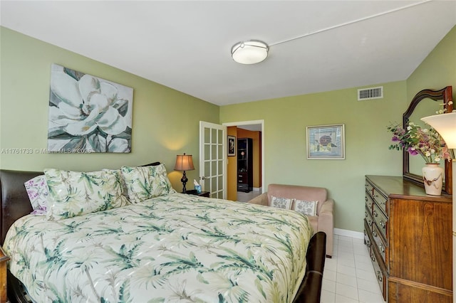 bedroom with visible vents, baseboards, and tile patterned flooring