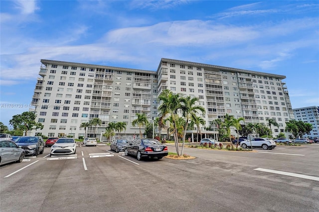 view of building exterior featuring uncovered parking