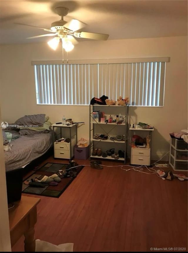 bedroom with ceiling fan and wood finished floors