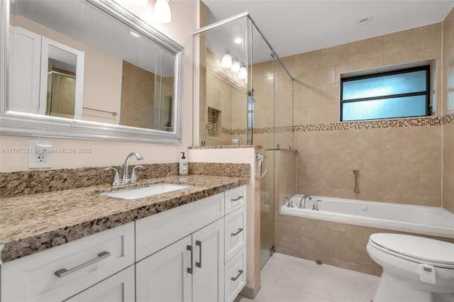 bathroom featuring tile patterned floors, toilet, a relaxing tiled tub, tiled shower, and vanity