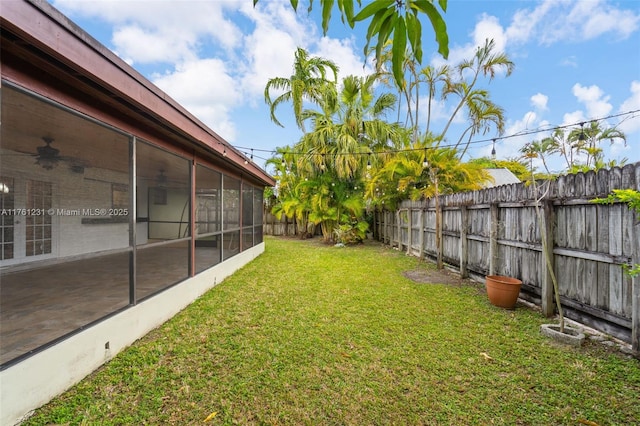 view of yard with a fenced backyard and a sunroom