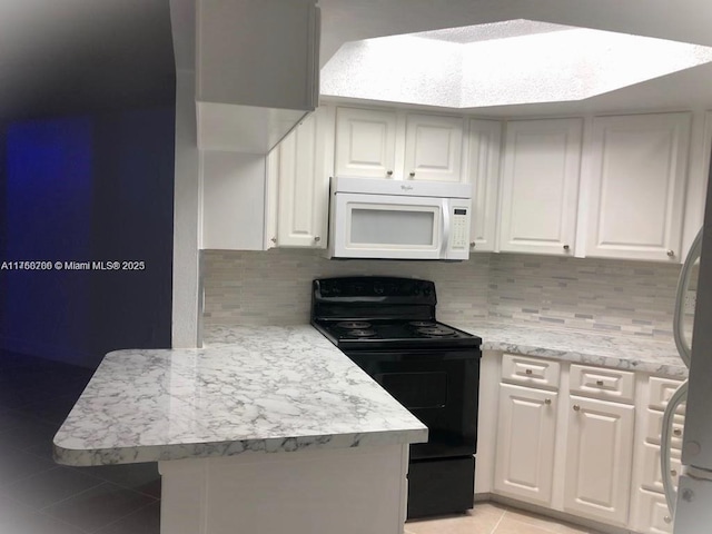 kitchen with white microwave, light tile patterned floors, a peninsula, black electric range, and white cabinets