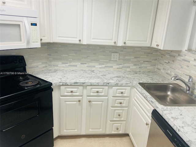 kitchen with white microwave, stainless steel dishwasher, black electric range, white cabinets, and a sink