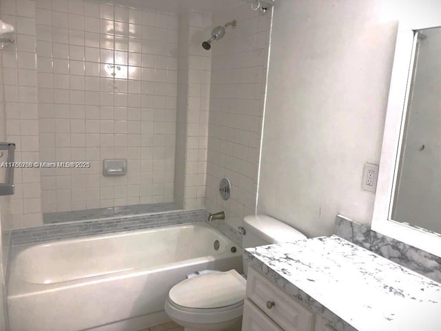 bathroom with tub / shower combination, toilet, and vanity