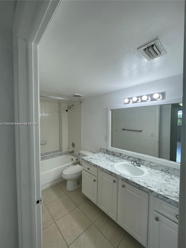 full bathroom with tile patterned flooring, visible vents, washtub / shower combination, toilet, and vanity