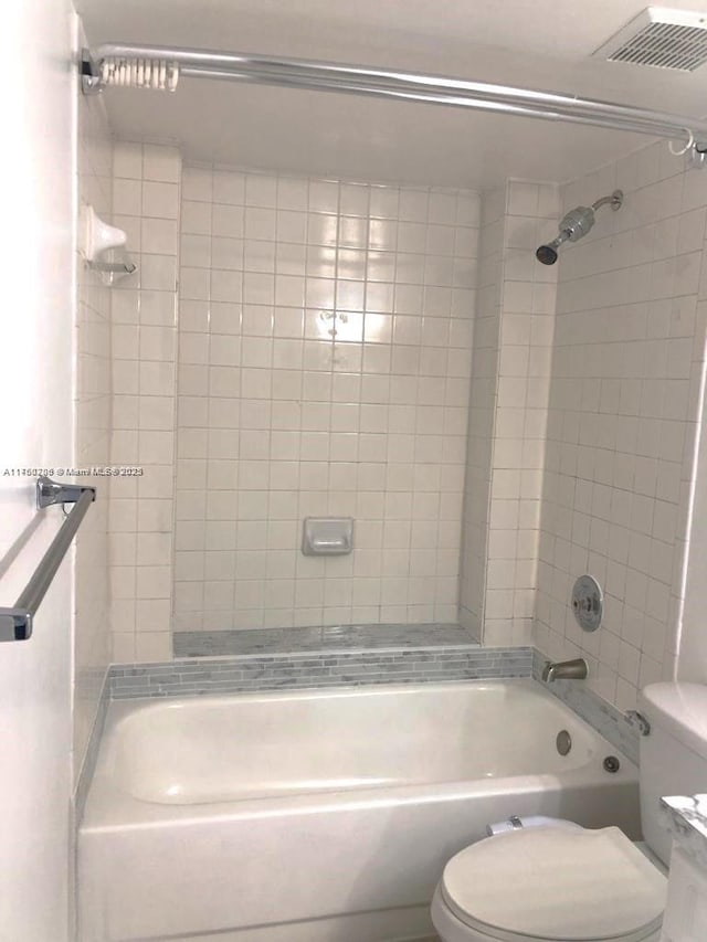 full bathroom with shower / bathing tub combination, toilet, and visible vents