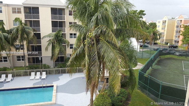 community pool featuring a patio area and fence