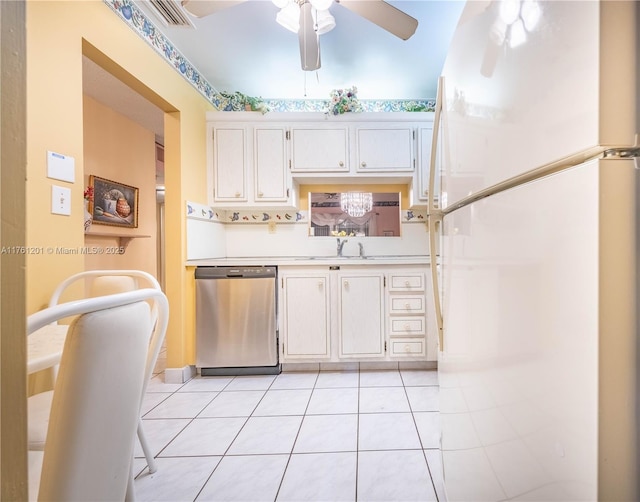 kitchen with light tile patterned floors, white cabinetry, freestanding refrigerator, light countertops, and stainless steel dishwasher