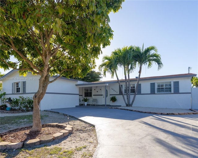 ranch-style home with concrete driveway and stucco siding