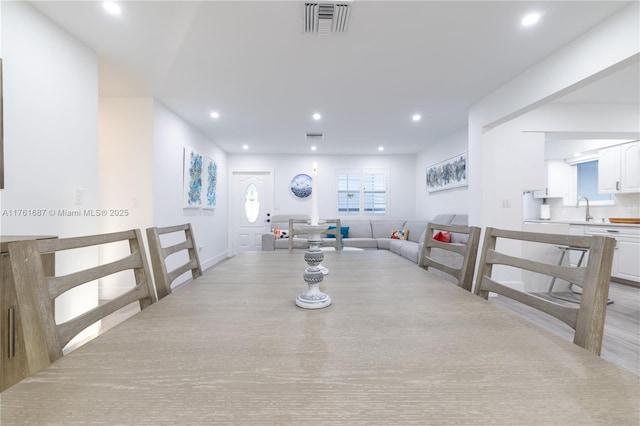 dining space with recessed lighting, visible vents, and light wood finished floors