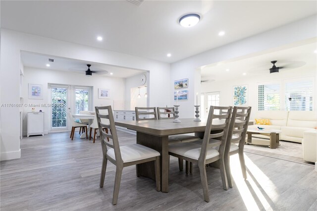 dining room featuring a ceiling fan, visible vents, baseboards, recessed lighting, and light wood-style floors