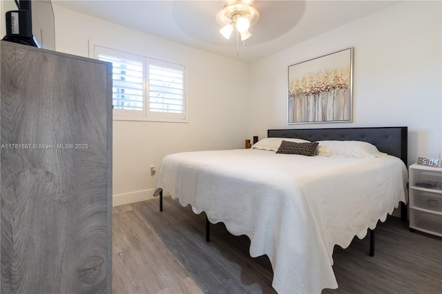 bedroom featuring ceiling fan, baseboards, and wood finished floors