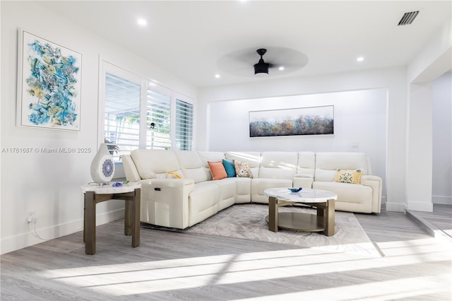 living room featuring visible vents, recessed lighting, and wood finished floors