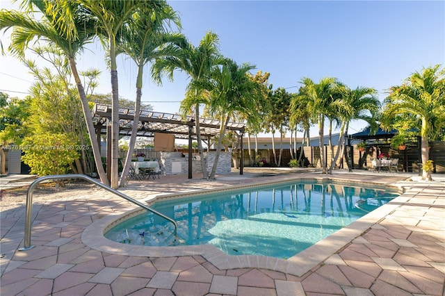 outdoor pool featuring a pergola, a patio, and fence