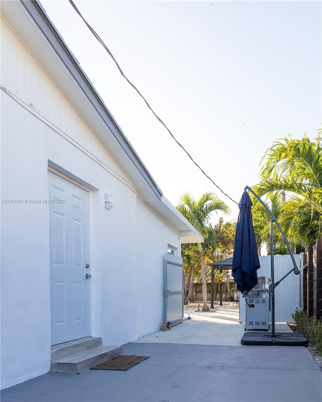 exterior space with stucco siding and fence