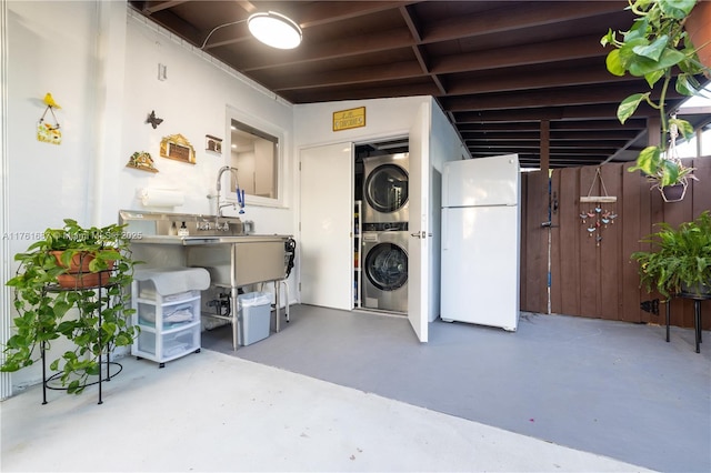 interior space featuring stacked washing maching and dryer