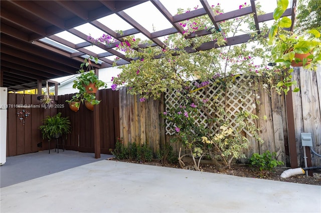 view of patio / terrace with a pergola and fence