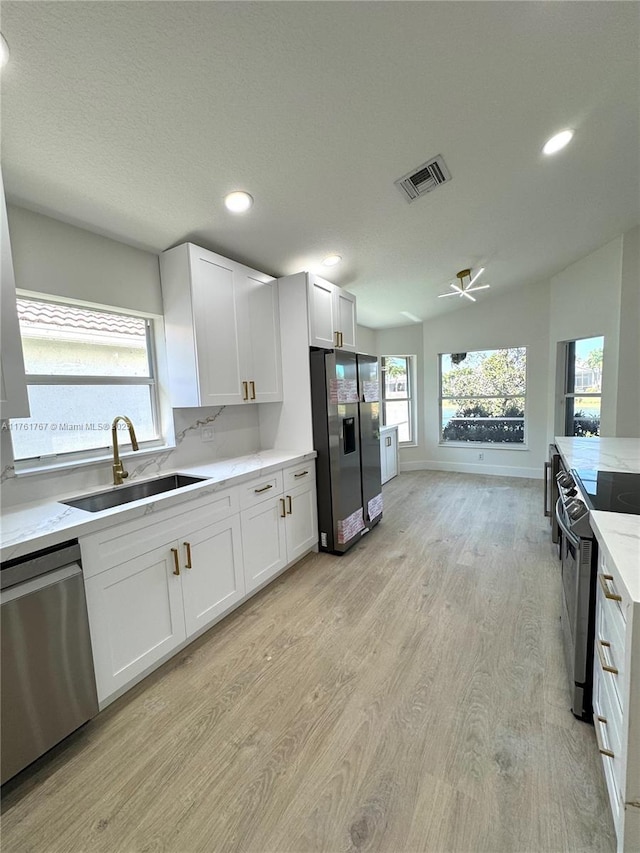 9785 San Luca St, Lake Worth, FL 33467 - kitchen with dishwasher, refrigerator with ice dispenser, electric range, a sink, and light wood-style flooring