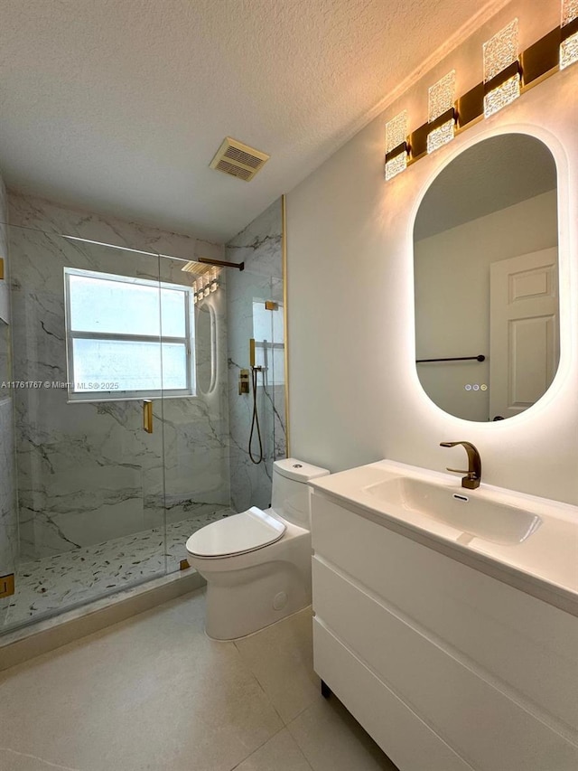 9785 San Luca St, Lake Worth, FL 33467 - full bathroom featuring a marble finish shower, toilet, vanity, and a textured ceiling