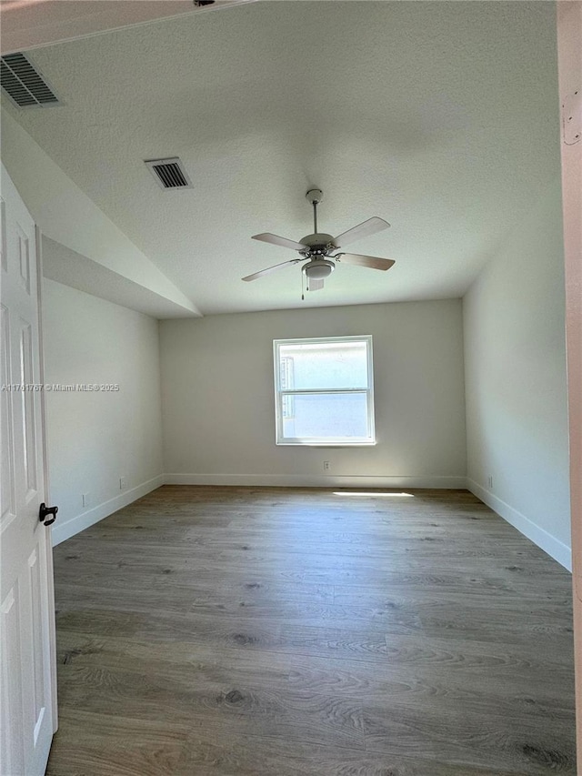 9785 San Luca St, Lake Worth, FL 33467 - unfurnished room with wood finished floors, a ceiling fan, baseboards, and a textured ceiling
