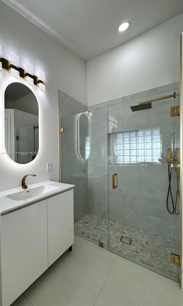 9785 San Luca St, Lake Worth, FL 33467 - bathroom with a shower stall, vanity, a textured ceiling, tile patterned flooring, and recessed lighting