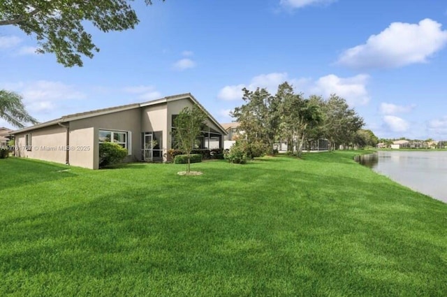 9785 San Luca St, Lake Worth, FL 33467 - view of green lawn featuring a water view