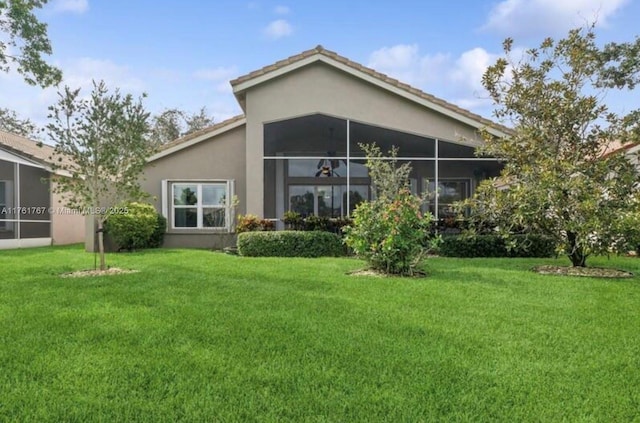 9785 San Luca St, Lake Worth, FL 33467 - back of house with stucco siding and a yard