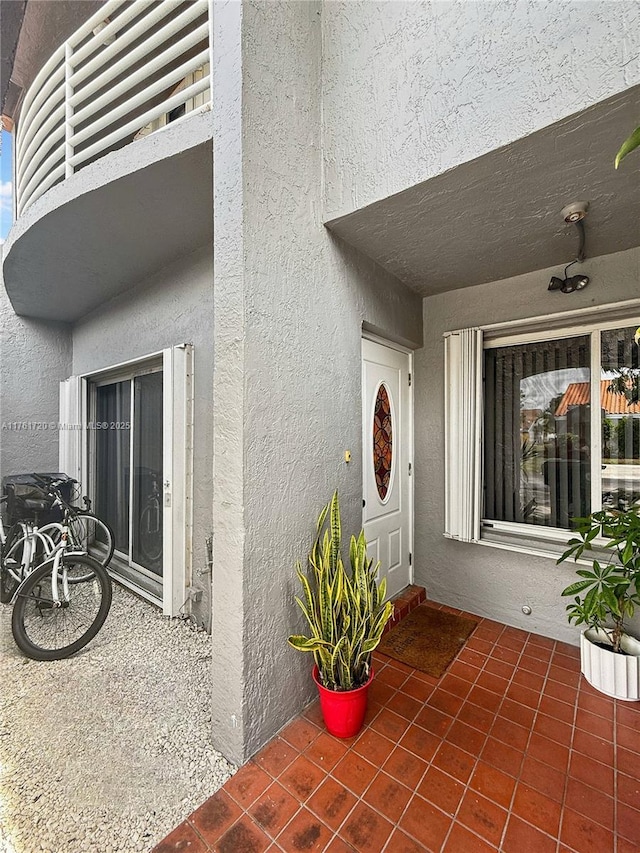 entrance to property featuring stucco siding