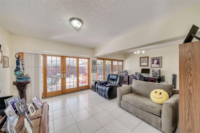 living area featuring light tile patterned flooring, a textured ceiling, french doors, and a notable chandelier