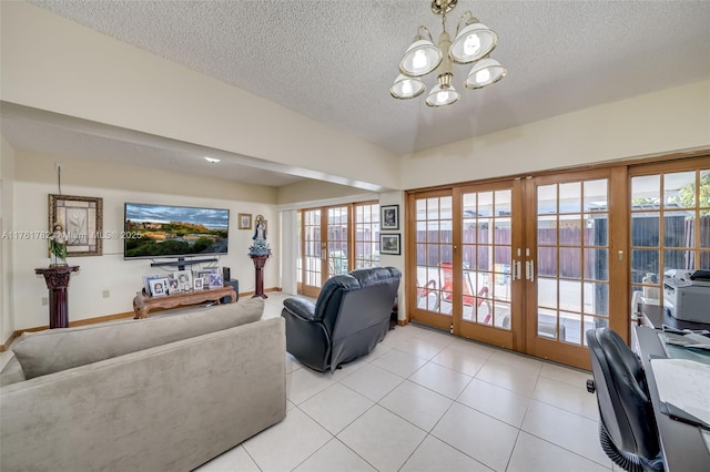 living area with lofted ceiling, a textured ceiling, french doors, and a notable chandelier