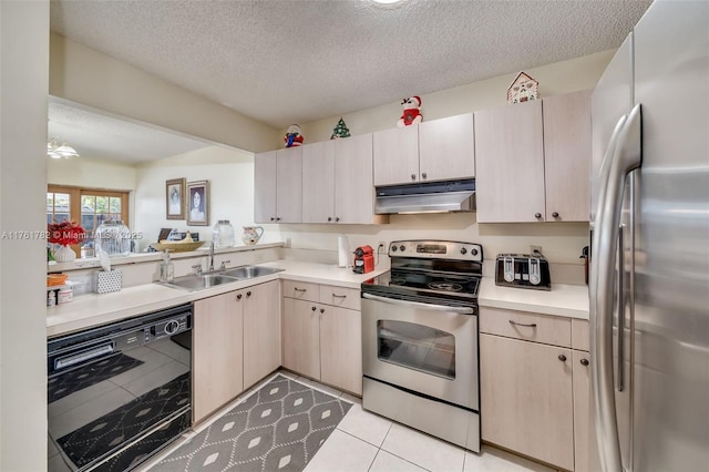 kitchen featuring light countertops, a sink, appliances with stainless steel finishes, and under cabinet range hood