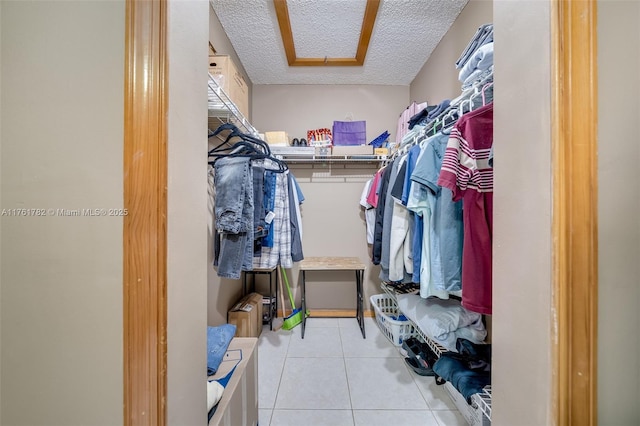 spacious closet featuring light tile patterned floors