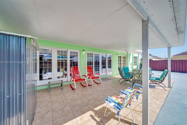 view of patio / terrace with fence, outdoor dining area, and french doors