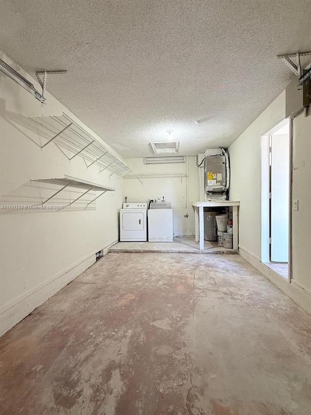 garage with baseboards and separate washer and dryer