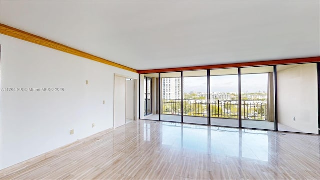 unfurnished room featuring expansive windows