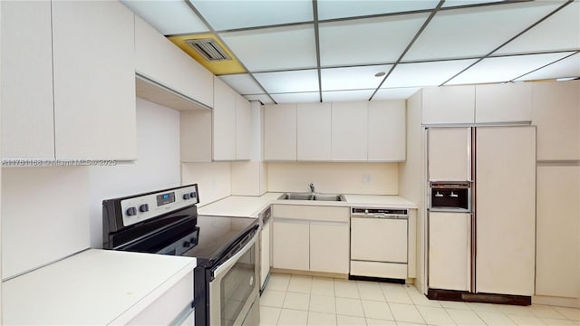 kitchen featuring white appliances, visible vents, a sink, light countertops, and a paneled ceiling