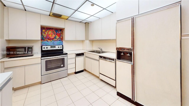 kitchen with stainless steel appliances, light countertops, and a sink