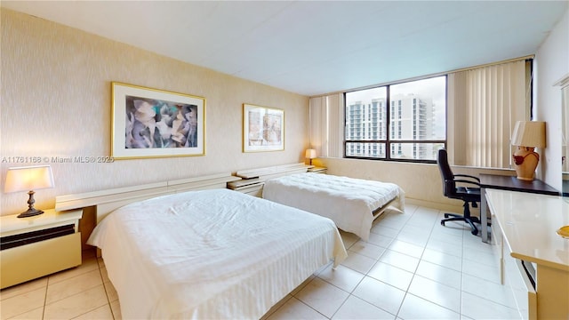 bedroom featuring light tile patterned flooring and wallpapered walls