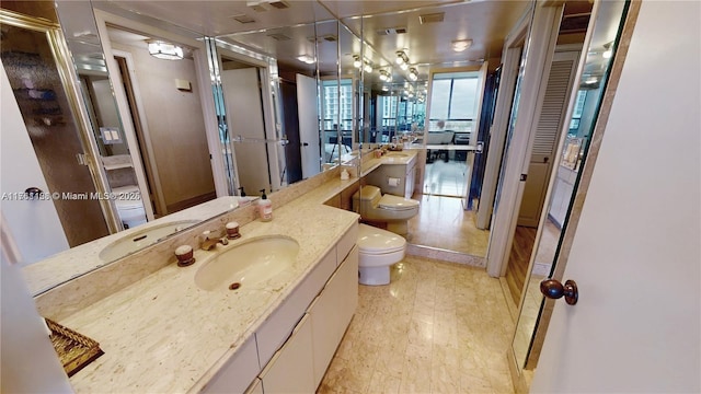 bathroom featuring a closet, visible vents, toilet, and vanity